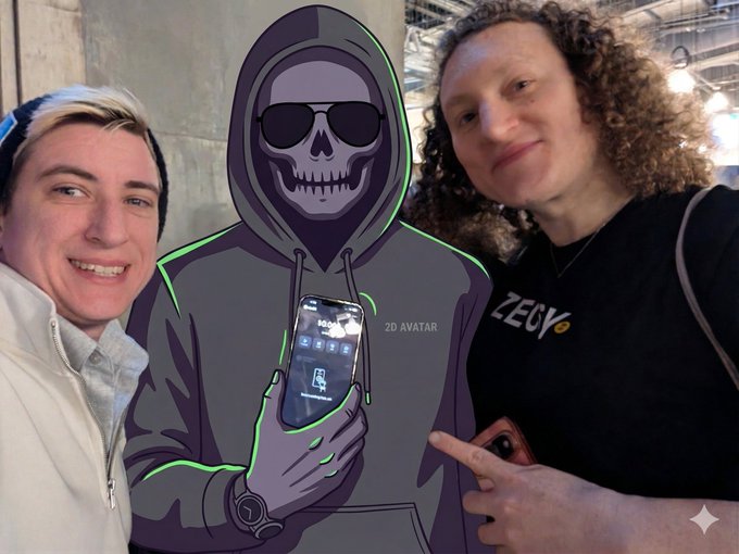 A photo of two smiling people posing next to a 2D cartoon avatar of a hooded skeleton wearing sunglasses and holding a smartphone, with one person pointing at it.
