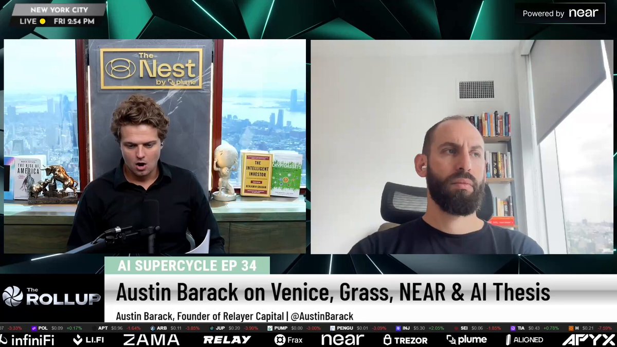 The image shows a TV screen displaying two men sitting at a desk, with one man wearing a black shirt and the other wearing a white shirt. They are talking about an AI thesis topic related to Venice Grass and Near & AI. The background of the image features a city skyline, adding context to their discussion. There is also text on the screen that reads " Austin Barack ( @AustinBarack ) on Why Venice, Grass, and NEAR Are The Most Undervalued AI Plays Timestamps 00:00".