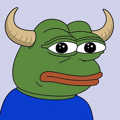 A cartoon illustration of a green, horned creature with large eyes and thick lips wearing a blue shirt against a light purple background.