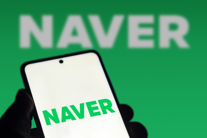 A smartphone displays the 'NAVER' logo in green text, with the same word blurred in the background.
