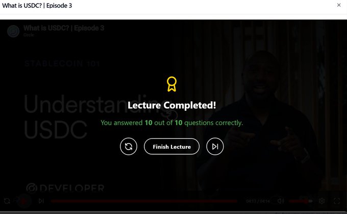 The image shows a computer screen displaying a video titled "What is USDC?". The screen also has a green checkmark symbolizing that the viewer has successfully completed an online course about USDC, with 10 questions answered correctly.