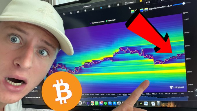 The image shows a man wearing a hat and pointing at a computer monitor displaying a bitcoin price graph, with a downward trend indicating that Bitcoin has crashed. The caption below the scene reads "This Is Dangerous For #BITCOIN... Watch NOW: youtu.be/dNASkH67iNE".