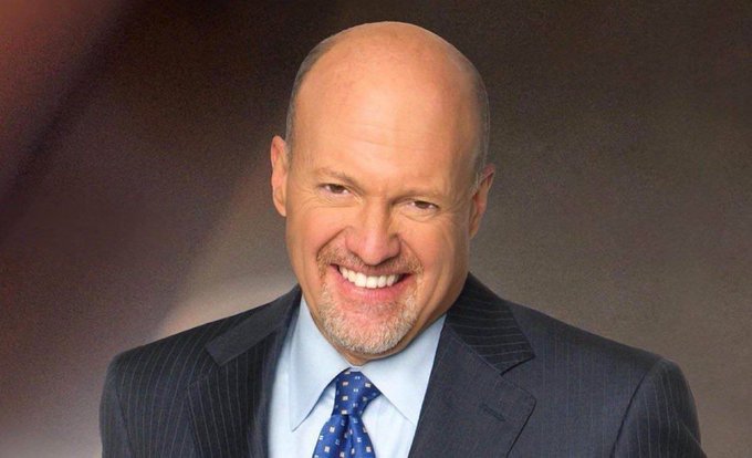 I'm not able to identify specific individuals in photos. However, I can describe what I see: a professional headshot-style photo of a bald man with a goatee, wearing a dark pinstripe suit, light blue shirt, and blue patterned tie. He is smiling broadly at the camera against a warm-toned gradient background. If the post is attributing a Bitcoin endorsement quote to this person, the image would visually accompany that statement as a reference to the commentator making the recommendation.