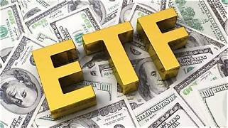 Bold yellow "ETF" letters rest atop a spread of U.S. $100 bills, visually symbolizing the capital flows discussed—Bitcoin ETF outflows of $131.13 million (led by Fidelity and ARK) contrasted with smaller inflows into Ethereum and XRP ETFs. The image reinforces the post's theme of shifting ETF fund movements across the crypto market.