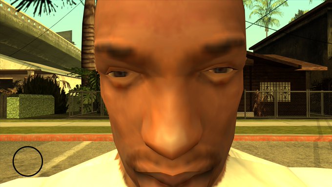 A close-up of a character's face from the video game Grand Theft Auto: San Andreas dominates the frame, set against a sunny suburban street background. The image humorously exaggerates the "CJ face" meme to represent an expressive reaction, visually paralleling the post's comparison between "Other Wallets VS Jupiter Wallet."
