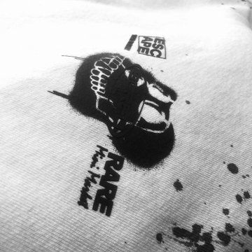 Black and white image showing a stylized lion or dragon head design printed on fabric, likely related to traditional Japanese folk performance.