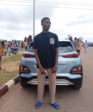 A man poses confidently in front of a sleek white Hyundai Kona SUV, wearing a black t-shirt, gray trousers, and blue sandals, with a bustling crowd visible in the background. The image humorously illustrates the "After web3" transformation, suggesting the newfound wealth and lifestyle upgrade that comes with success in the cryptocurrency space.