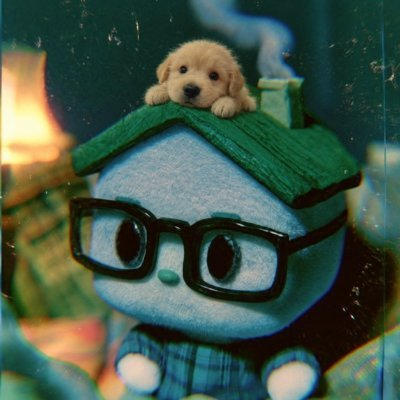 An artistic image shows a plush character with glasses and a green roof-shaped hat, with a small puppy resting on top.