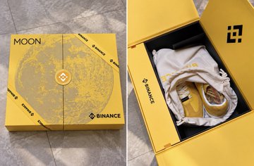 A yellow Binance "MOON" box, shown both closed with its moon design and opened to reveal a gold-colored coin and a piece of clothing inside.