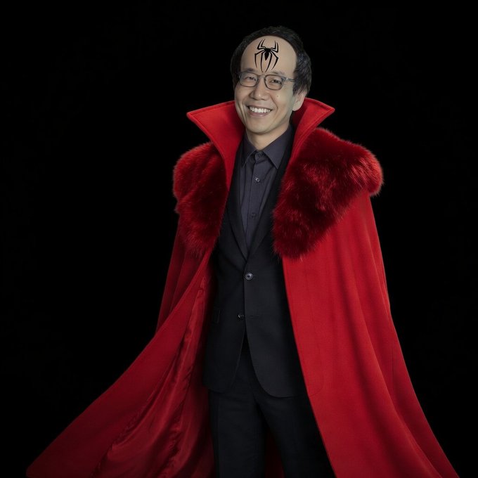 A smiling man in a black suit wears an elaborate red cape with fur trim and a Spider-Man mask digitally placed on his forehead, standing against a black background.

The image evokes a villainous or theatrical tone, suggesting skepticism or skepticism toward the low 36% prediction market odds for the CLARITY Act—portraying its passage as a dramatic or unlikely event.