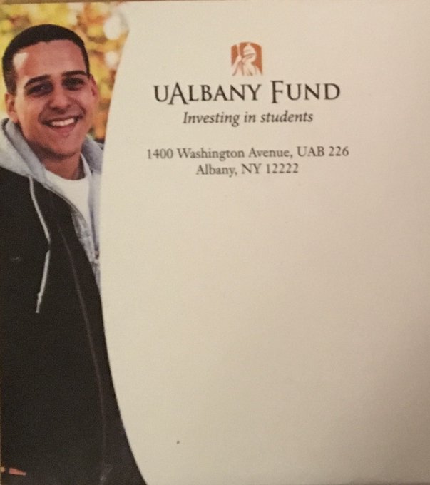 An envelope from 'UAlbany Fund - Investing in students' addressed to 1400 Washington Avenue, UAB 226, Albany, NY 12222, featuring a photo of a smiling male student.