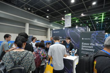 The Injective team showcases their booth at Global Web3 Developer Conference (GWDC), featuring signage reading "Enter the New Internet Economy" and engaging with visitors including representatives from Korean crypto media @tokenpost, as part of their active participation in the event.