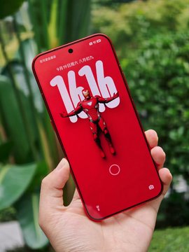 A hand holds up a red smartphone displaying a lock screen with the time 14:36, an anime character illustration, and Chinese text reading '开学快意踏入新起点' (Happy new school year).