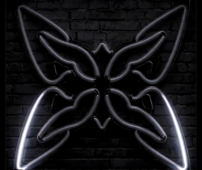 A decorative neon-style butterfly design with glowing white outlines set against a dark brick wall background.