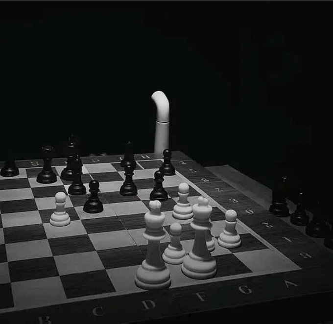 A monochromatic chessboard scene shows a white pawn standing alone in the distance, illuminated against a dark background, while a cluster of white pieces (king, queen, and pawns) and black pieces occupy the foreground. The caption relates to the post by visually symbolizing the $KAS token as the lone, resilient pawn facing off against numerous opposing pieces—reinforcing the message of staying patient and ignoring fear, uncertainty, and doubt (FUD) during a difficult market phase.