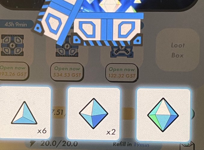 The image shows a close-up of a cell phone screen displaying a game interface with three different types of blue diamonds, each representing a level or stage within the game. The first diamond is located at the top left corner, the second one is in the middle right area, and the third one is on the bottom right side of the screen. The background appears to be a grayish color, possibly indicating that it's an older cell phone model.