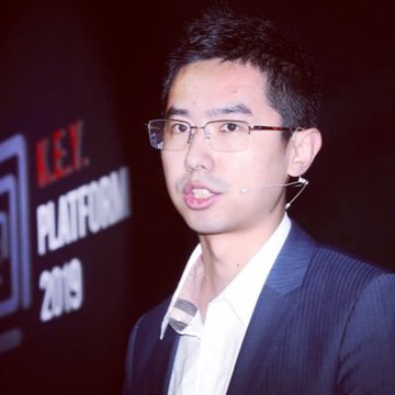 A man wearing glasses, a headset microphone, and a dark suit jacket speaks at an event, with the text "KEY PLATFORM 2019" visible on the backdrop behind him, relating to the post about Garrett and on-chain privacy by suggesting he is a public figure at a tech/blockchain conference who may need greater privacy for his communications and transactions.
