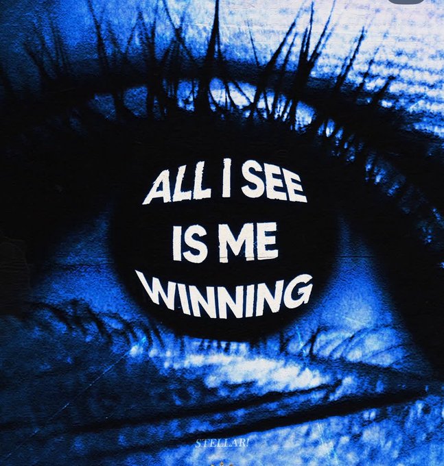 A stylized blue close-up of an eye features the white text "ALL I SEE IS ME WINNING" overlaid on the pupil, with "STELLAR" written at the bottom. The image reinforces the optimistic "good day" message by visualizing a winning, laser-focused mindset.