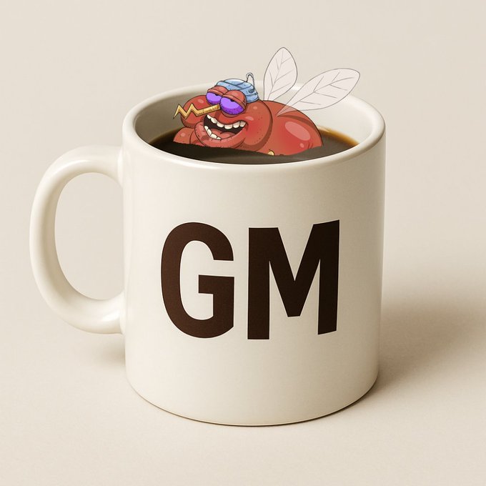 A white coffee mug labeled 'GM' with a cartoon fly wearing sunglasses lounging inside the coffee.