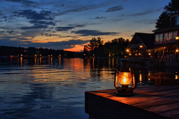 The image features a lantern sitting on a dock at night, with a beautiful sunset in the background. The scene suggests that this location could be near a lake or river where people can enjoy the peaceful atmosphere of the water during the evening hours. The image also includes text about Web3 and its growth factors, which may not have any direct connection to the lantern on the dock but could be related to the overall theme of the post.