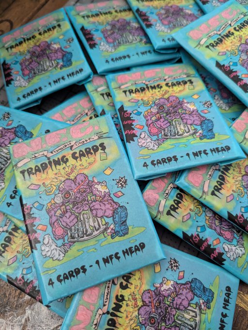 Multiple sealed trading card packs from Non Fungible Creeps (NFC) are stacked together, featuring vibrant graffiti-style artwork of a pink monster character, with each pack labeled "4 CARDS - 1 NFC HEAD." The image celebrates the brand's 4-year anniversary and the sold-out status of their trading card series.