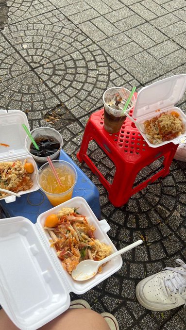 A casual outdoor meal of takeout containers with stir-fried noodles, rice, and drinks is spread across red and blue plastic stools on a stone-paved ground, with a person's white sneaker visible at the bottom.

The image of a relaxed street-food meal contrasts with the post's discussion of how the user's definition of "good DeFi" has matured from chasing the highest APY to focusing on what can actually go wrong—suggesting a laid-back lunch break moment while reflecting on TermMax's more risk-conscious approach.