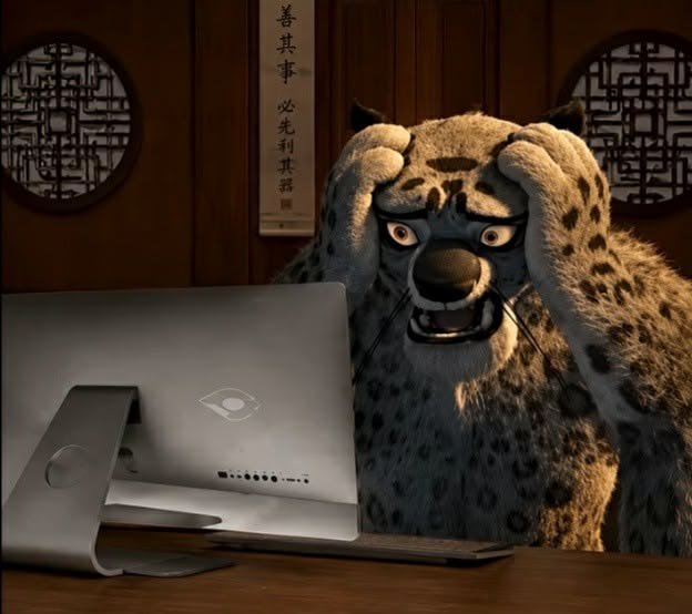 An animated snow leopard with wide, shocked eyes stares intently at a computer screen in a dimly lit room with Asian-style decor and calligraphy on the wall.