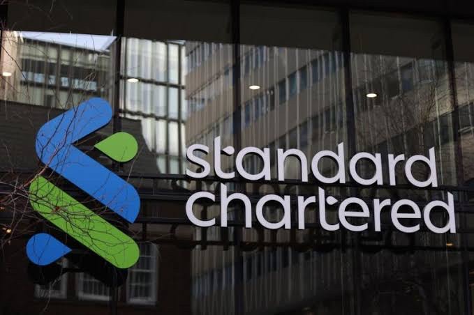 The Standard Chartered bank logo displayed on a glass building exterior, illustrating the bank's recent addition to the EU's MiCA register as a licensed crypto-asset service provider.