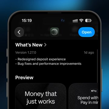 An iPhone screenshot showing an App Store 'What's New' page for version 1.27.0 with notes about a redesigned deposit experience and bug fixes, featuring a 'Money that just works' preview.