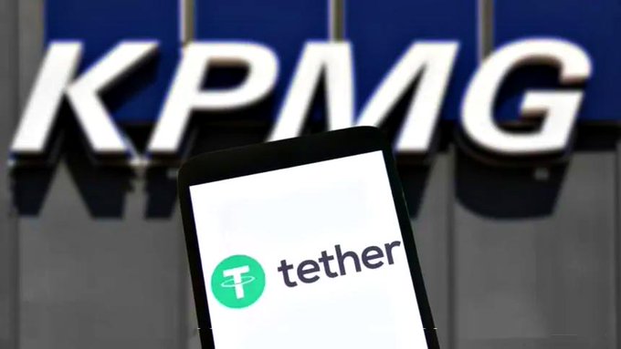 A smartphone displaying the Tether logo and "tether" text is shown in the foreground, with the KPMG logo prominently visible on a sign in the blurred background, illustrating Tether's first full audit conducted by KPMG.