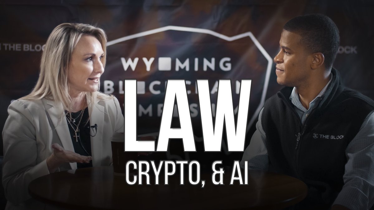 A promotional image for a Wyoming Blockchain Stampede event titled 'LAW, CRYPTO, & AI,' featuring a blonde woman in a blazer and a young man in a vest labeled 'THE BLOCK' facing each other.