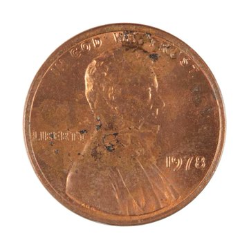 The reverse side of a 1978 Lincoln penny shows the Lincoln Memorial and the inscriptions 'ONE CENT,' 'IN GOD WE TRUST,' 'E PLURIBUS UNUM,' and 'UNITED STATES OF AMERICA.'