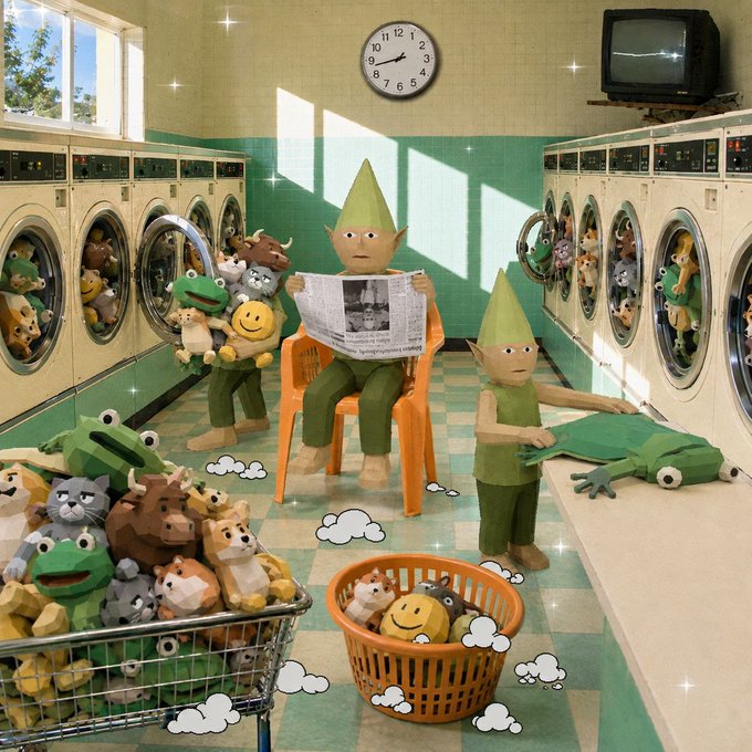 A whimsical 3D-rendered laundromat scene where green goblin-like characters wash stuffed animal toys, with one reading a newspaper and another folding a frog plushie.