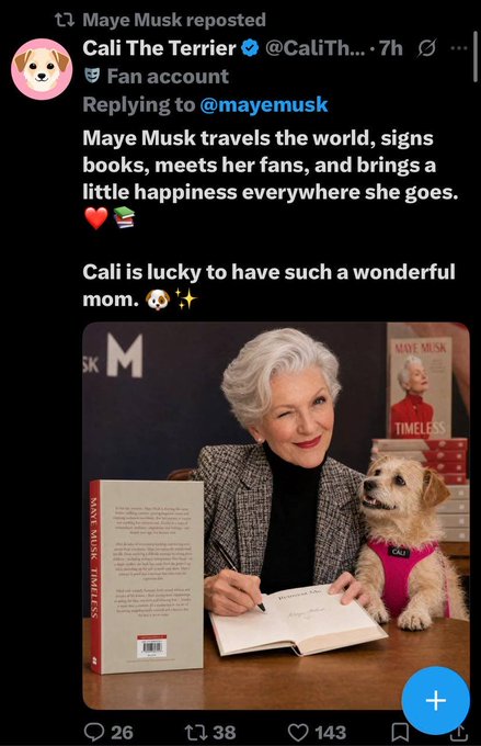 A screenshot of a reposted tweet from Maye Musk showing her signing a copy of her book 'TIMELESS' while her dog Cali sits beside her wearing a pink harness.