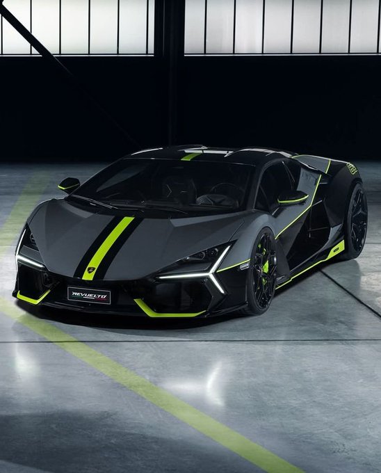 A black and neon green Lamborghini Revuelto sports car parked in a garage setting, featuring racing stripes and the name 'REVUELTO' on the license plate.