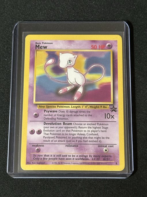 A first-edition Mew Pokémon trading card (1995 Wizards) in a protective sleeve, showing the Psychic-type with 50 HP and Devolution Beam attack.