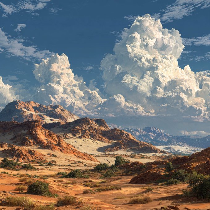 A scenic landscape photograph featuring red rock desert terrain and mountains beneath dramatic, towering cumulus clouds in a deep blue sky.