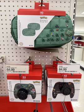 A Target store display features $84.99 Yo-Kai Watch video game cases and $64.99 Yo-Kai Watch controllers hanging on a pegboard. The "My wallet is not safe" caption reflects the steep prices on Nintendo Switch accessories, making this collector's haul a pricey temptation for fans.
