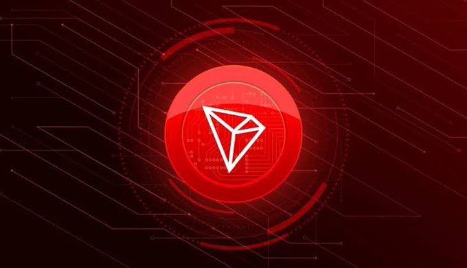 A digital graphic featuring the Tron (TRX) cryptocurrency logo — a white triangular symbol inside a glossy red circle — set against a dark red circuit-pattern background.