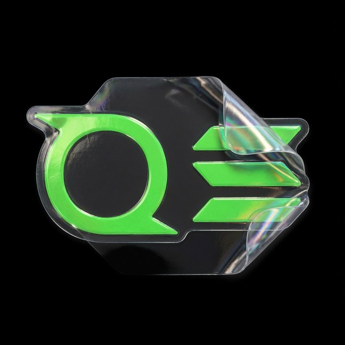 A 3D rendering of a Green Lantern symbol emblem with a glossy, transparent, glass-like finish on a black background.