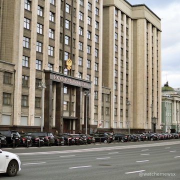 A large government building in Moscow with a golden emblem, with rows of police motorcycles parked along the street, watermarked @watchemewsx.