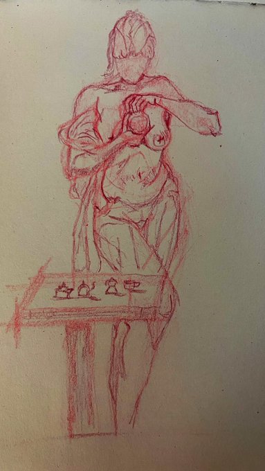 A rough red crayon or chalk sketch of a figure behind a counter, holding what appears to be a cup or mug, with stylized Japanese characters along the front of the counter.