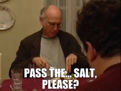 The image features a man sitting at a table with a glass of water next to him. The text "Pass the salt, please?" is written above his head. This phrase seems to be part of an advertisement or promotional material for a product related to trading in electronic markets.