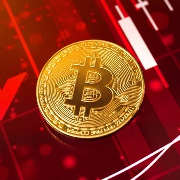 A physical Bitcoin token rests on a red candlestick chart, visually representing the bearish market forecast for $BTC, which Kalshi traders predict could dip to $74,000 this month. The coin's engraved text—"BITCOIN DIGITAL DECENTRALIZED PEER TO PEER"—ties directly to the cryptocurrency's downturn highlighted in the post.