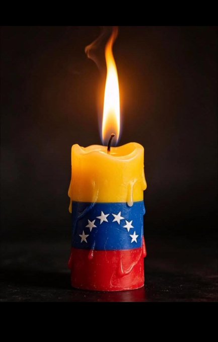 A melting candle decorated with the colors of the Venezuelan flag (yellow, blue, and red with white stars) burning with a flame against a dark background.