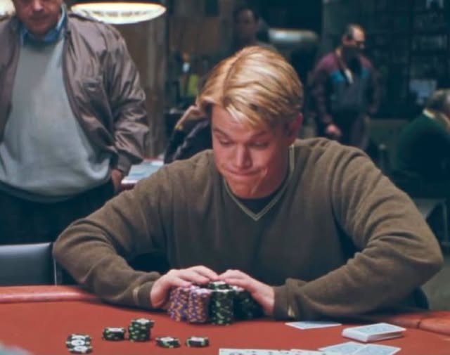 A scene from the movie Rounders showing Matt Damon's character sitting at a poker table with chips stacked in front of him.