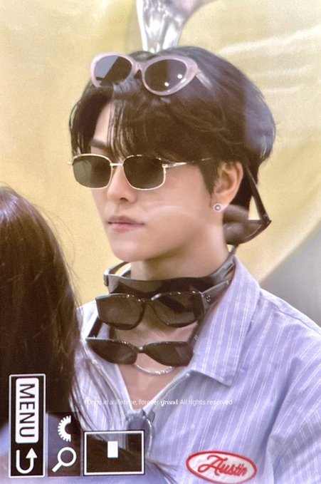 A person wearing multiple sunglasses stacked on their head and around their neck, paired with a light purple striped shirt. The image includes a "MENU" UI element and a "Fussn" logo, with a caption referencing XINLONG (씬롱) of ALD1, suggesting it's a fan-taken photo of the K-pop idol from Alpha Drive One.