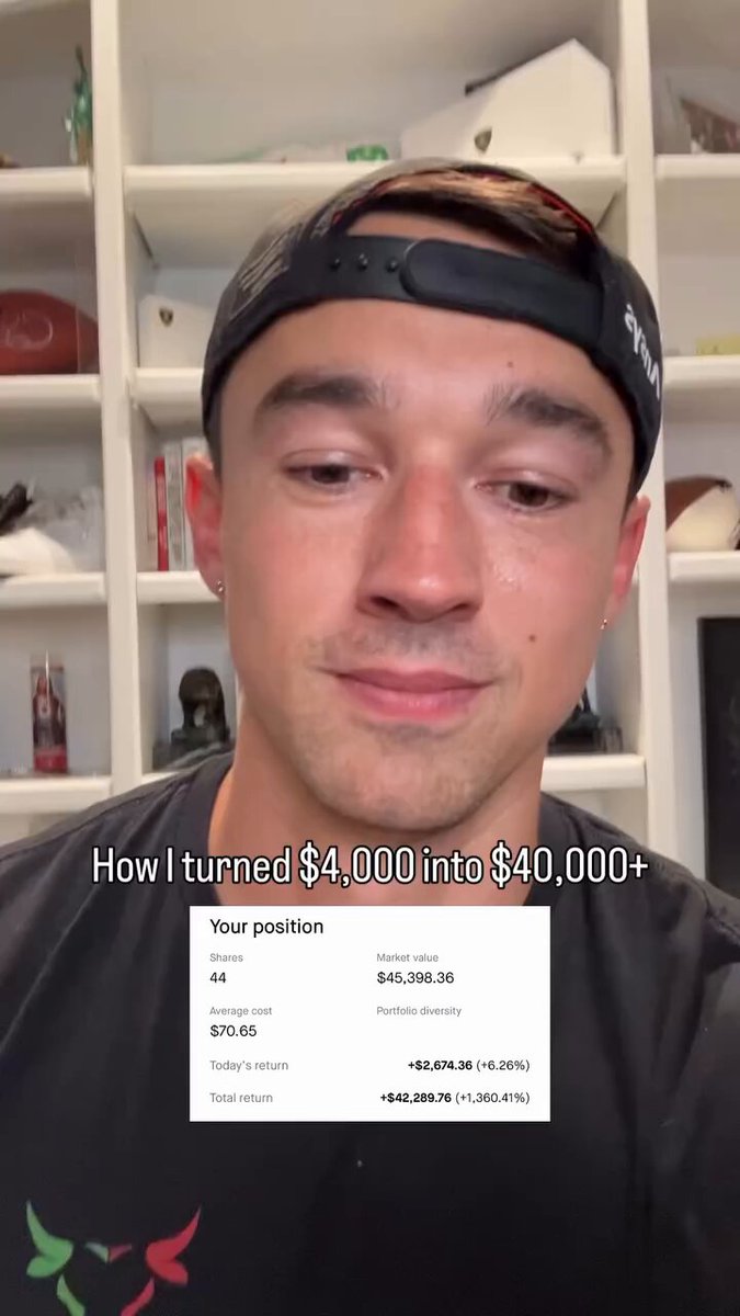 In the image, there is a man wearing a black baseball cap standing against white walls inside his home. The man seems to be taking a selfie while holding up an electronic device that displays some text. The electronic device appears to be a phone or tablet, with the content of which I cannot determine. 

The post in the image is related to "How I turned $4,000 into $40,000+ Make money day trading, and put that money to work for you Big winner". It seems like the man has gained some kind of financial success by participating in a specific activity or venture, perhaps through stock trading.