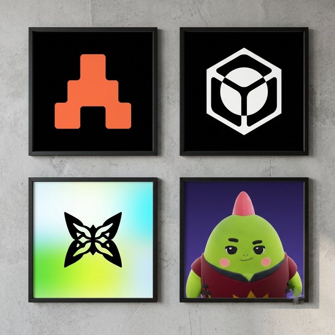 Four framed art prints displayed on a wall, featuring an orange robot logo, a white hexagon emblem, a holographic butterfly design, and a green cartoon character with a pink mohawk.