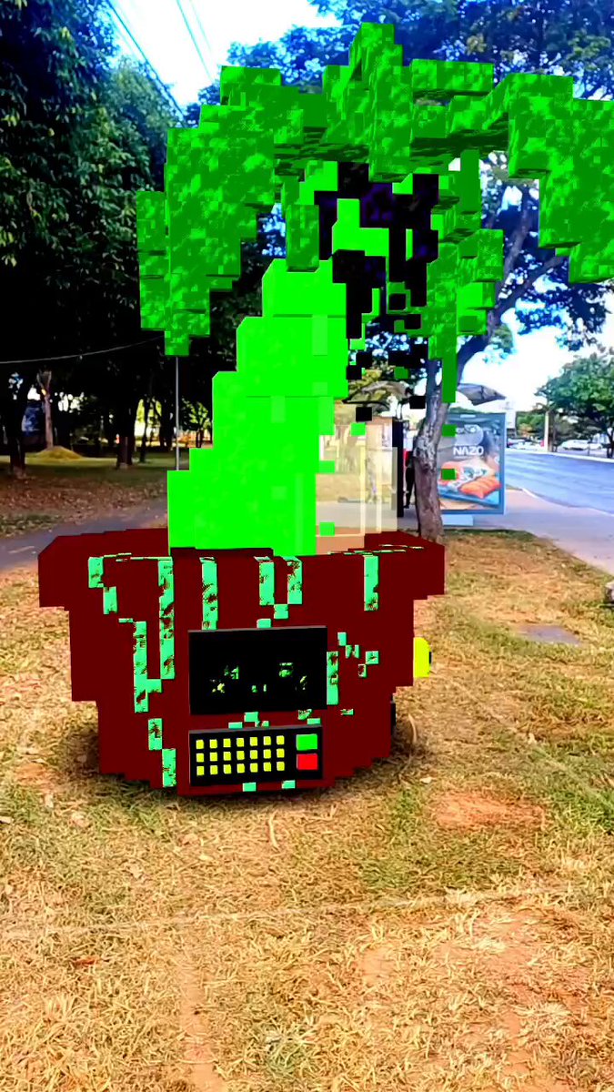 The image features a large tree made out of Lego bricks, with green leaves and branches that give it an appearance similar to a bonsai tree. The Lego structure stands tall against a backdrop of trees and grass, creating a unique and eye-catching display. The photo is accompanied by a caption that reads "Sunset Bonsai Made for #proofofpalm 2026 event Thank you @absurdeity @taimei_886 @SujiGR and @DtheletterD for collect 6/10 4.20 tez".